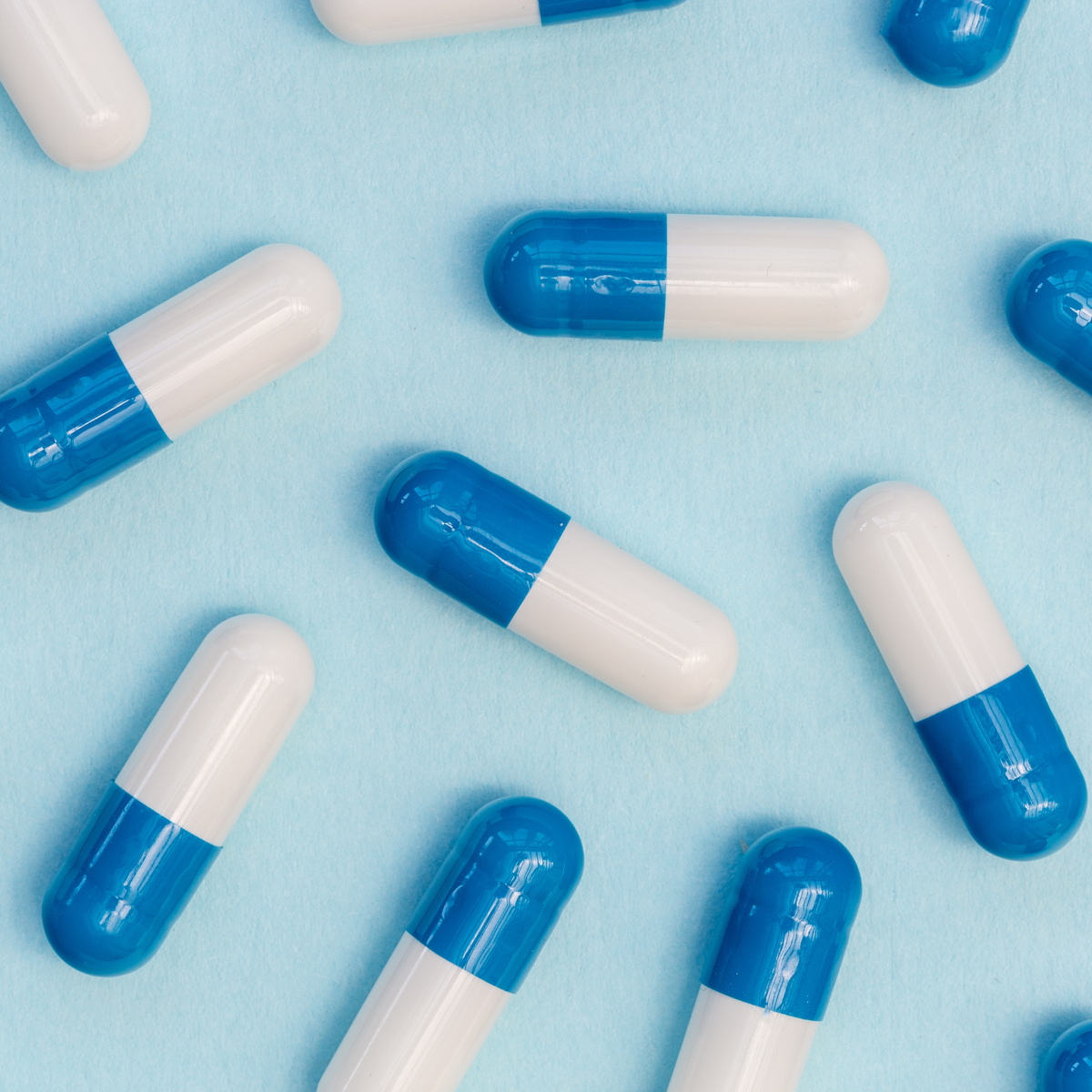 pharmaceutical tablets on blue background