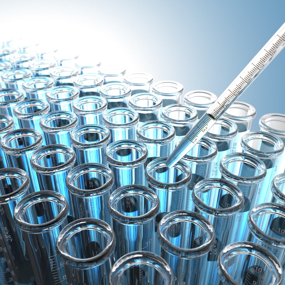 Laboratory Pipette with Blue Liquid Over Glass Test Tubes.-1